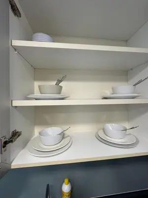 a kitchen shelf with bowls and plates on it at Casa Residency RH Homes in Kuala Lumpur