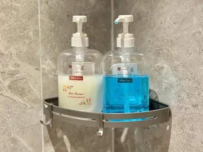 two bottles of detergent sitting on a shelf in a bathroom at 2min walk to TRX,KLCC view Gaming 2pax swimming pool in Kuala Lumpur