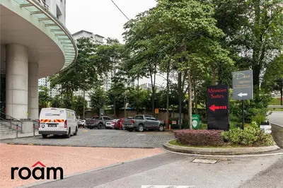 a car parked in a parking lot next to a building at Dua Sentral Transit Suites KL Sentral in Kuala Lumpur