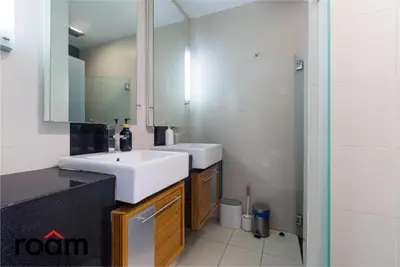 a bathroom with two sinks and a mirror at Dua Sentral Transit Suites KL Sentral in Kuala Lumpur
