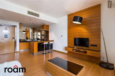 a living room with wood paneling and a flat screen tv at Dua Sentral Transit Suites KL Sentral in Kuala Lumpur