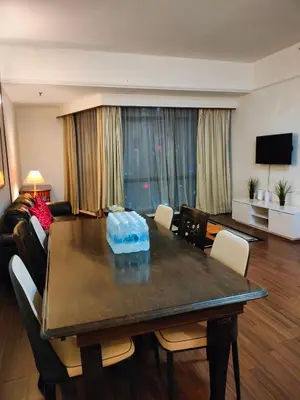 a living room with a dining room table with chairs at KL Brave Suite at Times Square in Kuala Lumpur