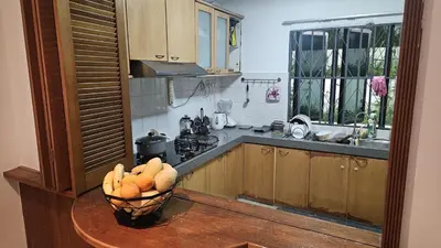 a kitchen with a bowl of fruit on a table at Cozy Private Room in Taman Desa with Shared Bathroom in Kuala Lumpur