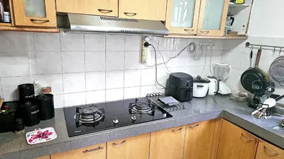 a kitchen with a stove top oven in a kitchen at Cozy Private Room in Taman Desa with Shared Bathroom in Kuala Lumpur