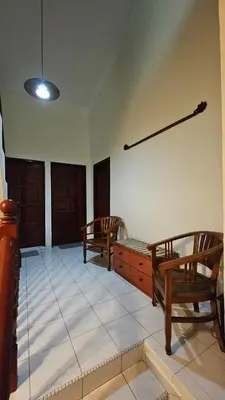a living room with two wooden chairs and a table at Cozy Private Room in Taman Desa with Shared Bathroom in Kuala Lumpur