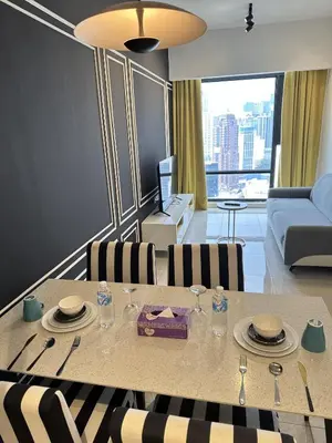 a living room with a table and a couch at Axon Suites near at Pavilion with Rooftop Panoramic City View in Kuala Lumpur