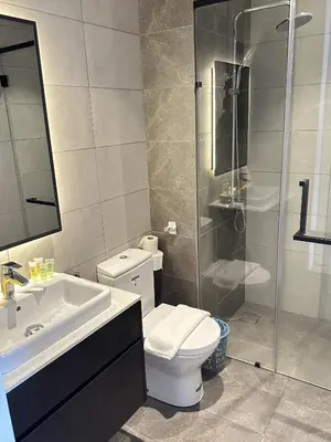 a bathroom with a toilet and a sink and a shower at Axon Suites near at Pavilion with Rooftop Panoramic City View in Kuala Lumpur