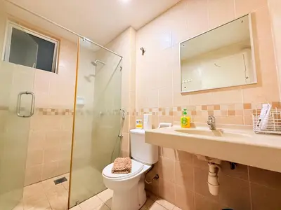 a bathroom with a shower and a toilet and a sink at CozyHome Suites Casa Mutiara in Kuala Lumpur