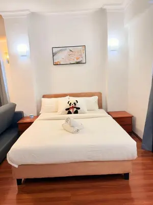 a bedroom with a bed with a stuffed animal on it at CozyHome Suites Casa Mutiara in Kuala Lumpur
