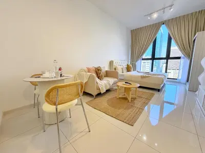 a living room with a couch and a table at Majestic Charming Studio Suite with Infinity Pool in Kuala Lumpur