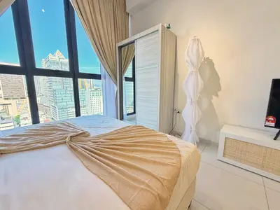 a bedroom with a large bed with a large window at Majestic Charming Studio Suite with Infinity Pool in Kuala Lumpur