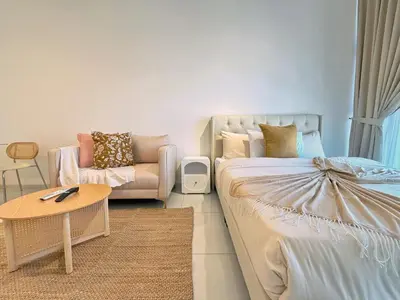 a living room with a bed and a couch at Majestic Charming Studio Suite with Infinity Pool in Kuala Lumpur