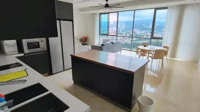 a kitchen and living room with a view of a city at Pomelo Meet Kuala Lumpur in Kuala Lumpur