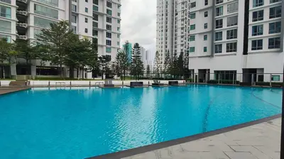a large blue swimming pool in the middle of buildings at Pomelo Meet Kuala Lumpur in Kuala Lumpur