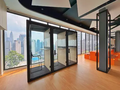 an office with large windows with a view of the city at Majestic Modern Studio Suites with Infinity Pool in Kuala Lumpur