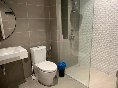 a bathroom with a toilet and a glass shower at Premier suites at Quill Residence KL in Kuala Lumpur