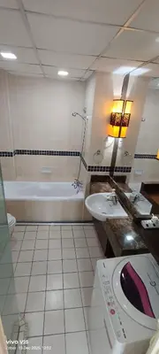 a bathroom with a tub and a sink and a bath tub at Greenstone suites at Seri Bukit Ceylon in Kuala Lumpur