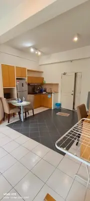 a living room with a kitchen and a table at Greenstone At Seri Bukit Ceylon klcc in Kuala Lumpur