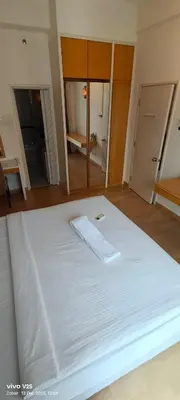 a large white bed in a room at Greenstone At Seri Bukit Ceylon klcc in Kuala Lumpur