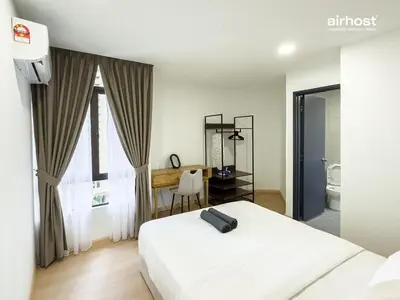 a bedroom with a white bed and a desk and window at Villa Putra Condo PWTC by Airhost in Kuala Lumpur