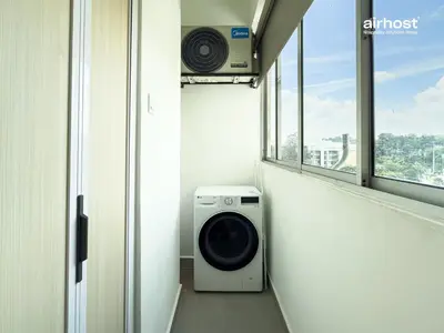 a washing machine in a room with a window at Villa Putra Condo PWTC by Airhost in Kuala Lumpur