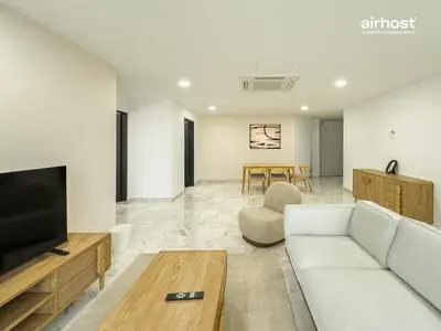 a living room with a couch and a tv and a table at Villa Putra Condo PWTC by Airhost in Kuala Lumpur