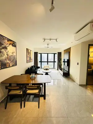 a living room with a table and a couch at Agile Delima Sky View Apartment at TRX Bukit Bintang in Kuala Lumpur