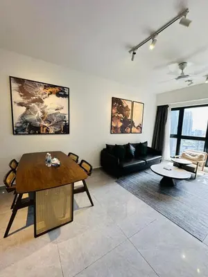 a living room with a table and a couch at Agile Delima Sky View Apartment at TRX Bukit Bintang in Kuala Lumpur