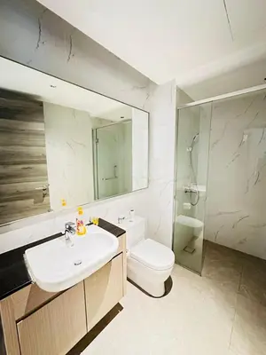 a bathroom with a sink and a toilet and a mirror at Agile Delima Sky View Apartment at TRX Bukit Bintang in Kuala Lumpur