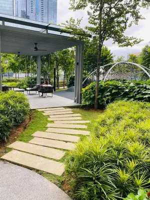 a walkway in a park with a bench and trees at Agile Bukit Bintang Homestay KLCC in Kuala Lumpur