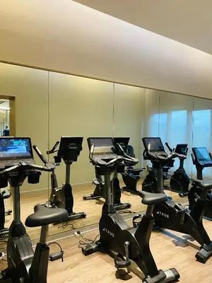 a gym with rows of exercise bikes and a mirror at Agile Bukit Bintang Homestay KLCC in Kuala Lumpur
