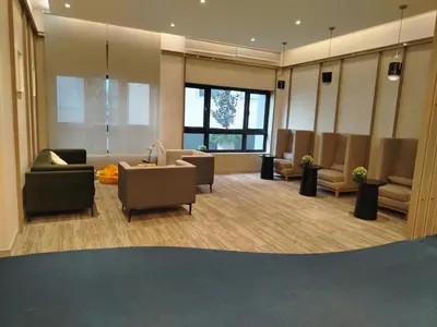 a waiting room with couches and chairs in a building at Agile Bukit Bintang Homestay KLCC in Kuala Lumpur