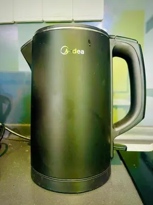 a black coffee cup sitting on a counter at Scarletz Residence KLCC Rooftop Pool in Kuala Lumpur