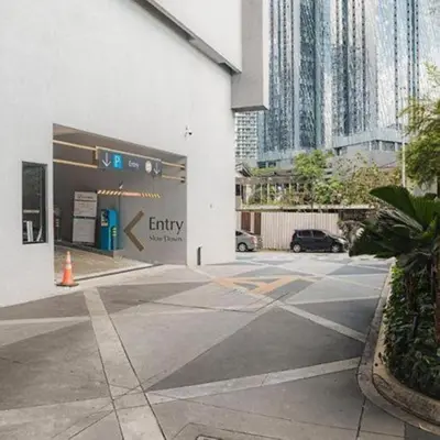 an empty parking lot in a city with tall buildings at Scarletz Residence KLCC Rooftop Pool in Kuala Lumpur