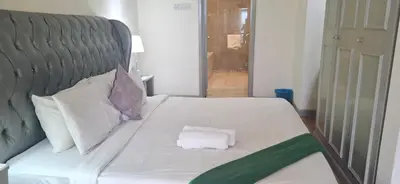 a white bed with two pillows on it at Relax Suite Times Square Kl in Kuala Lumpur