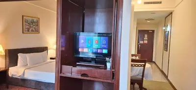 a room with a bed and a flat screen tv at Relax Suite Times Square Kl in Kuala Lumpur