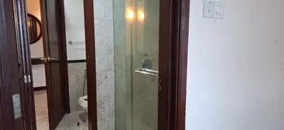 a bathroom with a glass shower with a toilet at Relax Suite Times Square Kl in Kuala Lumpur