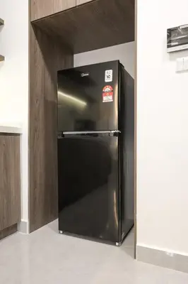 a stainless steel refrigerator in a kitchen at Agile Bukit Bintang By NexxField in Kuala Lumpur
