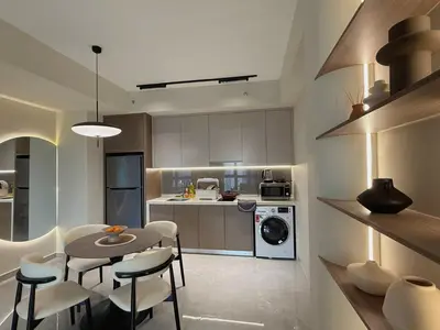 a kitchen with a table and chairs in a kitchen at 3PX Deluxe Suites Agile Bukit Bintang, Walkable Pavilion & TRX & MRT in Kuala Lumpur