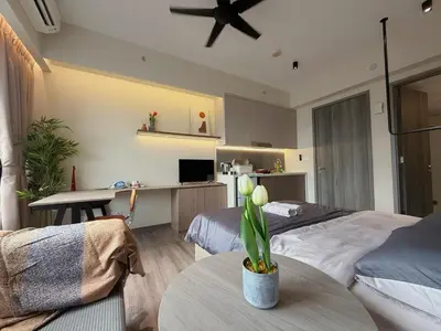 a bedroom with two beds and a table with a plant at 2PX Comfy Suite, Agile Bukit Bintang Near TRX, Pavilion, MRT TRX in Kuala Lumpur