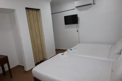 a small room with a bed and a television at Haven Hotel Pudu in Kuala Lumpur
