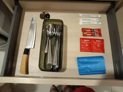 a drawer with utensils on top of a shelf at Kampung Marsa at Majestic Residence, Kuala Lumpur in Kuala Lumpur