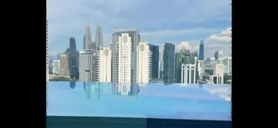 a view of a city skyline from a swimming pool at Kampung Marsa at Majestic Residence, Kuala Lumpur in Kuala Lumpur