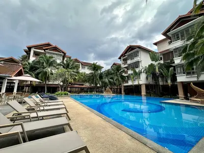 a swimming pool with lounge chairs and a hotel at 183 Ampang KLCC by Widebed in Kuala Lumpur