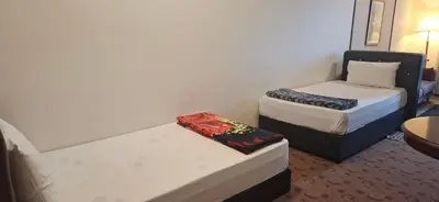 a small room with two beds and a table at B Service apartment times Square kl in Kuala Lumpur