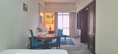 a dining room with a table and blue chairs at B Service apartment times Square kl in Kuala Lumpur