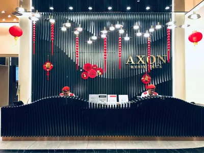 two men are sitting at a stage in a store at Axon Residence Glaxay Suite Bukit Bintang KL in Kuala Lumpur