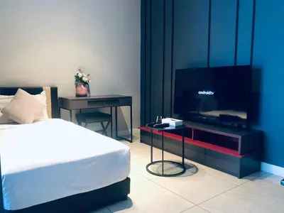 a bedroom with a bed and a flat screen tv at Axon Residence Glaxay Suite Bukit Bintang KL in Kuala Lumpur