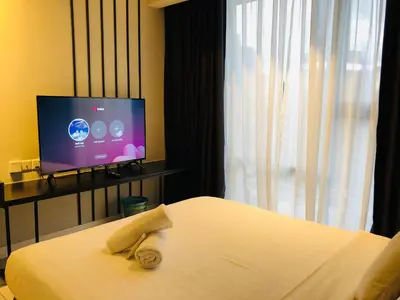 a hotel room with a bed and a flat screen tv at Axon Residence Glaxay Suite Bukit Bintang KL in Kuala Lumpur