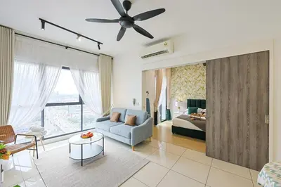 a living room with a blue couch and a bed at Continew Residensi City Comfort Stay Cozy 1BR 1BA in Kuala Lumpur